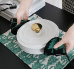 black and green pot grabber with a matching placemat