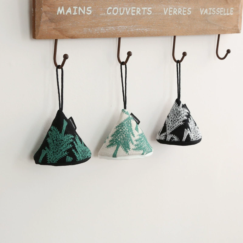 3 Embroidered Pot Grabber in white black on a wall