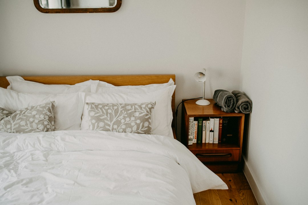Cozy small guest bedroom with a neatly made bed and simple bedside table