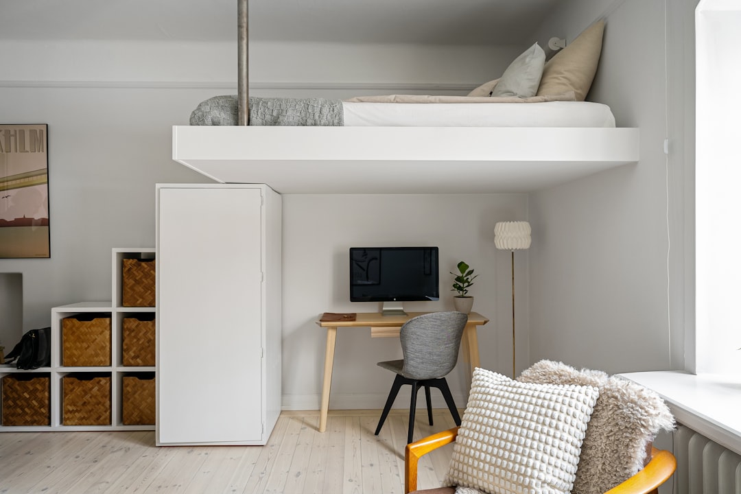 Loft bed with desk below as space-saving furniture for a studio apartment