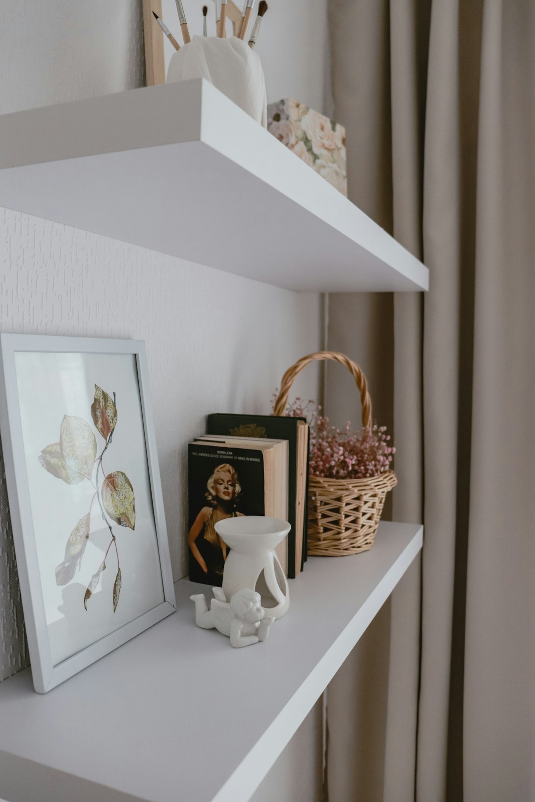 Small apartment bathroom shelf organized with baskets and everyday essentials